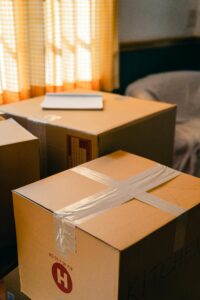 Sunlit room with cardboard boxes, indicating a move or delivery process.